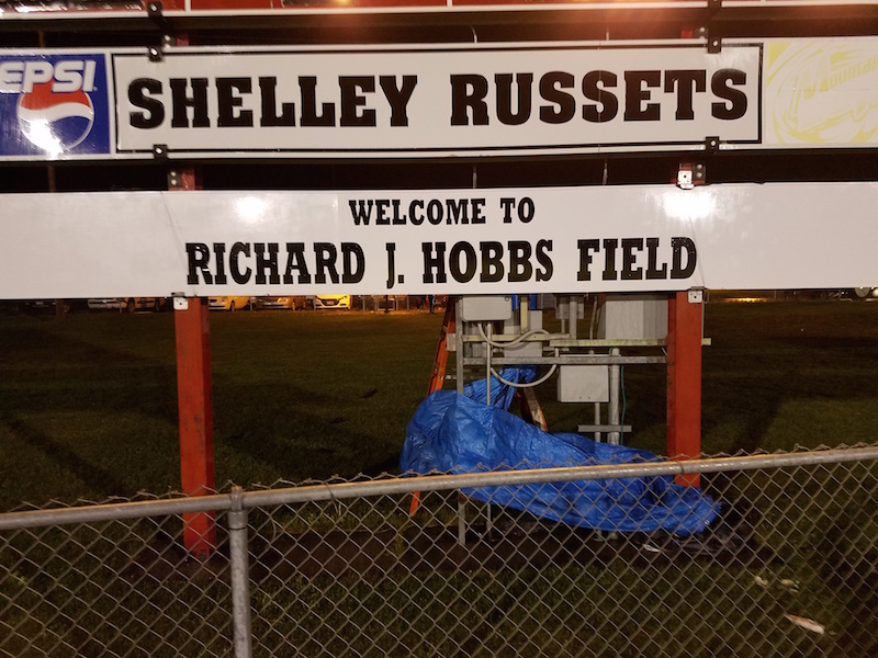 Shelley football coach surprised as district names field after him